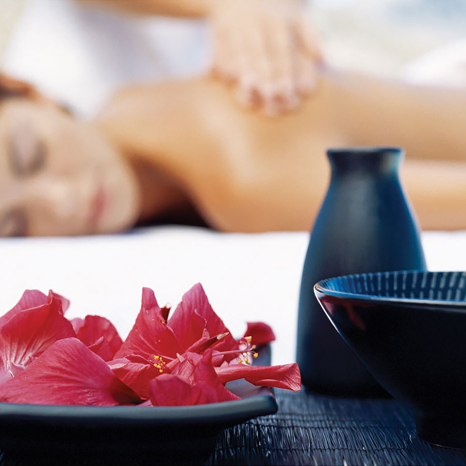 Relax women lies faced down while receiving massage | Karisma Hotels & Resorts®