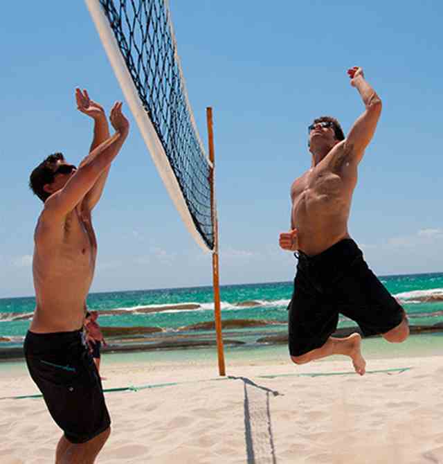 Men playing beach volleyball at Karisma Hotels & Resorts®