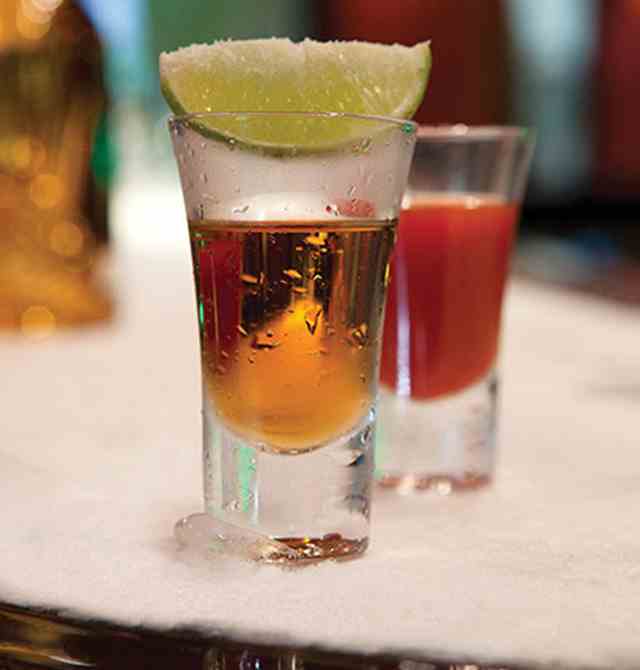 Gold tequila shot with a half a slice of lime on the glass top with salt at Karisma Hotels & Resorts®