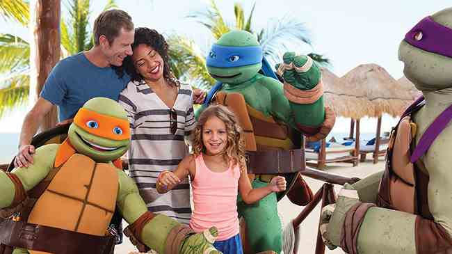 Family enjoying taking photos with Teenage Mutant Ninja Turtles