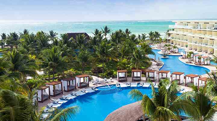 overview of the infinite river and pool with cabanas at azul beach resort riviera cancun